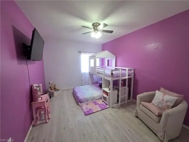 a bedroom with a bed and flat screen tv