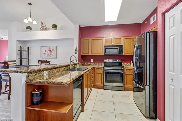 a kitchen with stainless steel appliances granite countertop a stove and a refrigerator