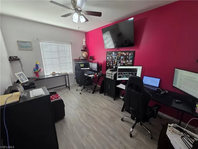 a view of a workspace with furniture and a window