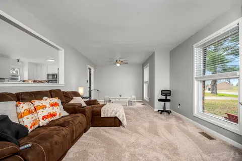 a living room with furniture and a large window