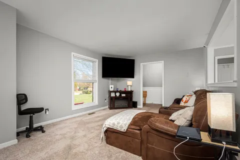 a living room with furniture and a flat screen tv with wooden floor