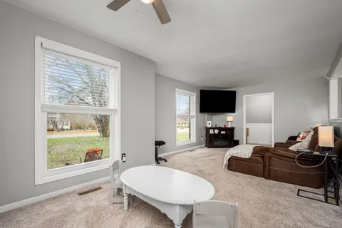 a living room with furniture and a flat screen tv