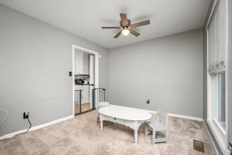 a room with a window and a ceiling fan