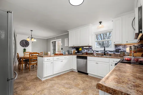 a kitchen with cabinets a sink and appliances