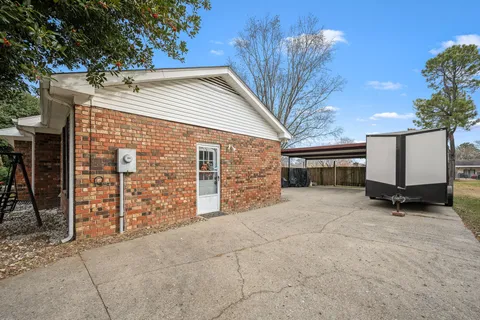 a view of parking area with wooden fence