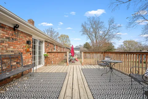 a view of a roof deck with wooden floor and fence