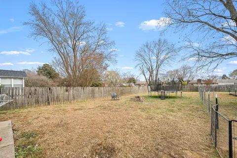 a backyard of a house with lots of trees