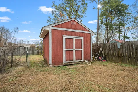 a backyard of a house with table and chairs