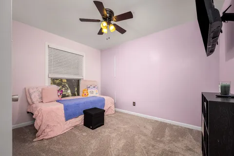 a bedroom with a bed and a chandelier