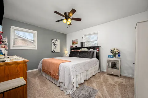a bedroom with a bed and a chandelier