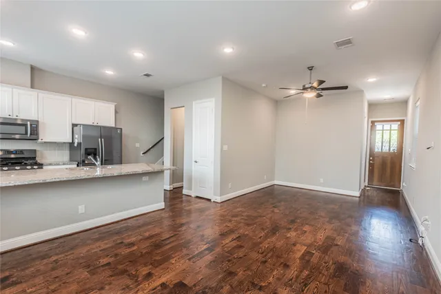 a view of kitchen with stainless steel appliances refrigerator stove microwave and cabinets