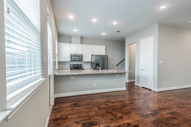 a view of kitchen with wooden floor and window