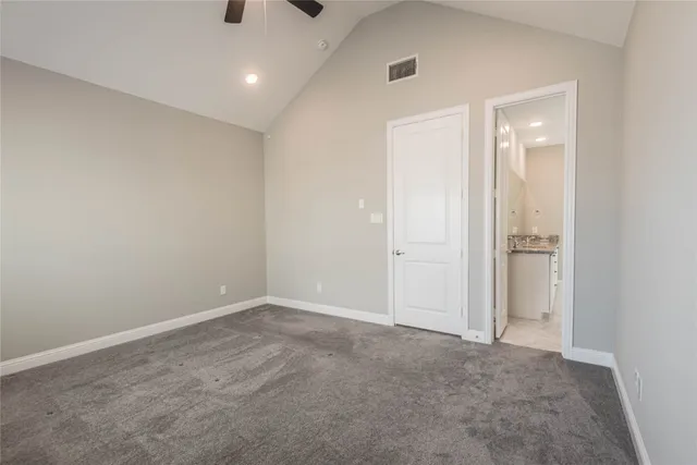 an empty room with an entryway and entrance to other room