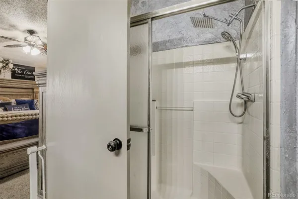 a bathroom with a glass shower door