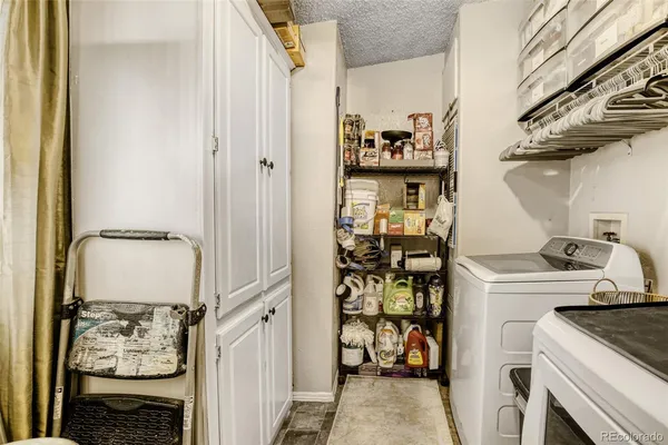 a kitchen with a refrigerator and a stove top oven