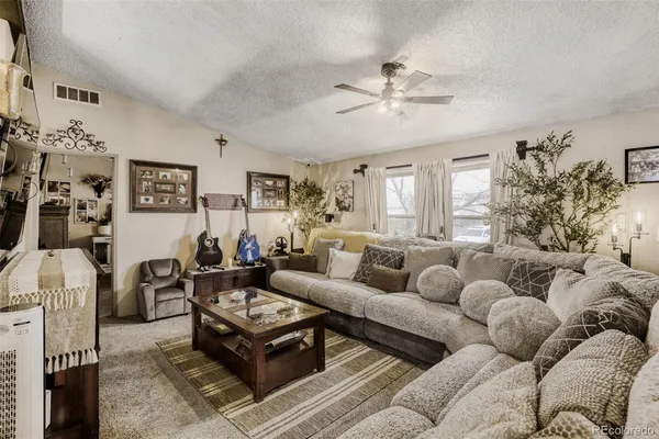 a living room with furniture and a chandelier