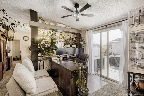 a view of a workspace with furniture and a floor to ceiling window