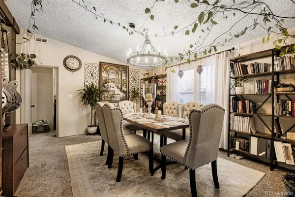 a view of a dining room with furniture and a chandelier