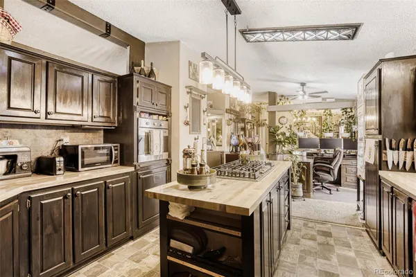 a kitchen with stainless steel appliances granite countertop a stove and a refrigerator