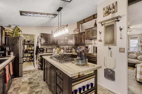 a kitchen with stainless steel appliances granite countertop a stove and a refrigerator