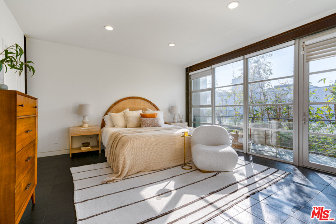 25 Brooks Avenue, Unit 3 Venice, CA 90291 - Photo 13 of 34 a bedroom with a bed and a large window