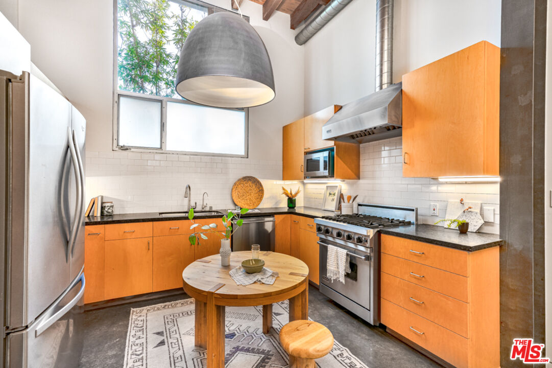 25 Brooks Avenue, Unit 3 Venice, CA 90291 - Photo 7 of 34 a kitchen with stainless steel appliances a stove a sink and a refrigerator