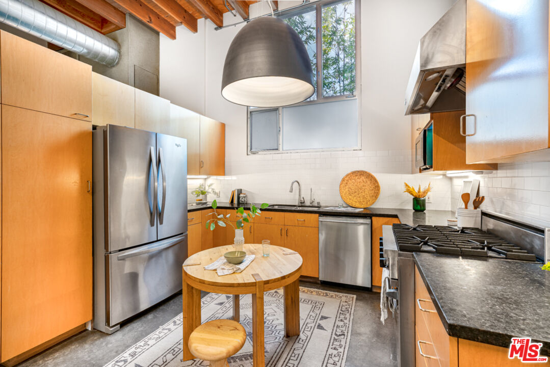 25 Brooks Avenue, Unit 3 Venice, CA 90291 - Photo 8 of 34 a kitchen with stainless steel appliances granite countertop a sink a stove and a refrigerator