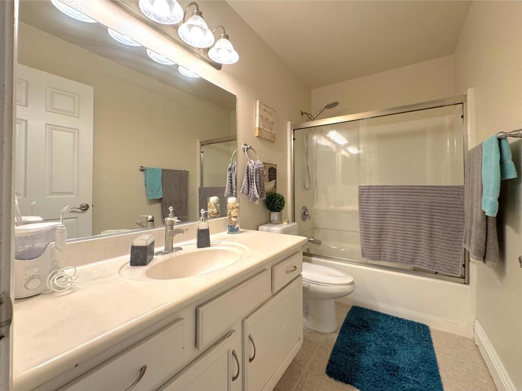 472 Graves Avenue, Unit 12 El Cajon, CA 92020 - Photo 8 of 10 a bathroom with a sink a toilet a mirror and shower
