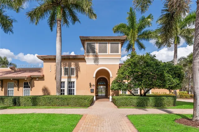 a view of a house with a yard and sitting area
