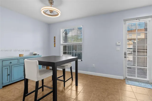 a view of a dining room with furniture and window