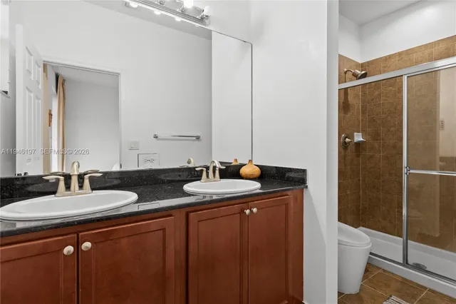 a bathroom with double sink and mirror