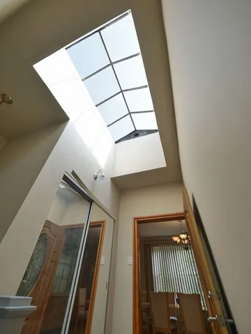 a view of a dining room and livingroom with furniture wooden floor a chandelier