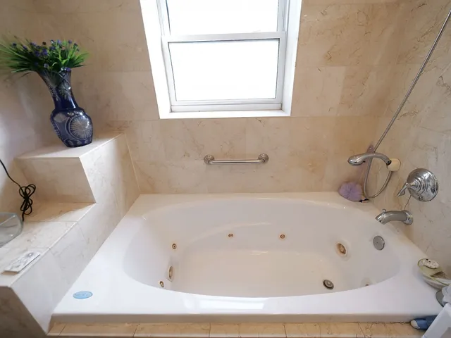 a view of a hallway with wooden floor and chandelier