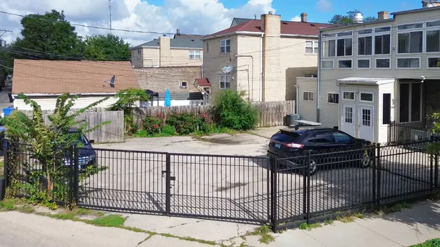 a view of a house with a small yard and a patio