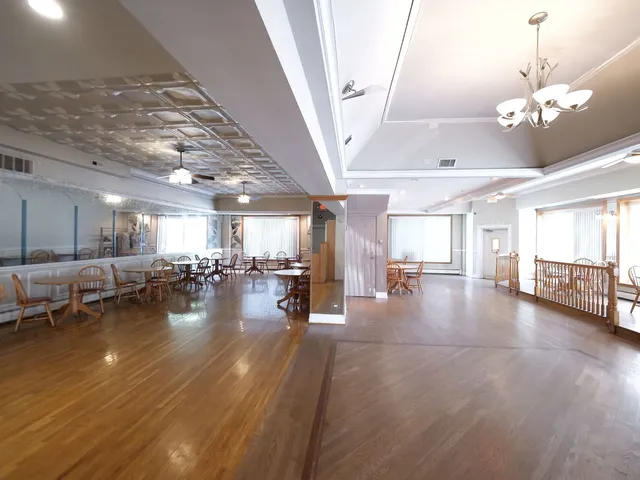a view of a living room and kitchen with furniture wooden floor and window