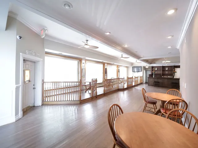 a kitchen with granite countertop a stove a sink and a refrigerator
