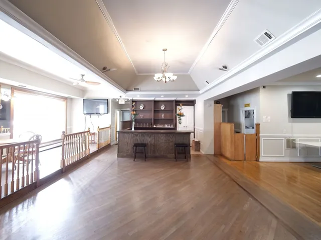 a dining room with lots of furniture and wooden floor