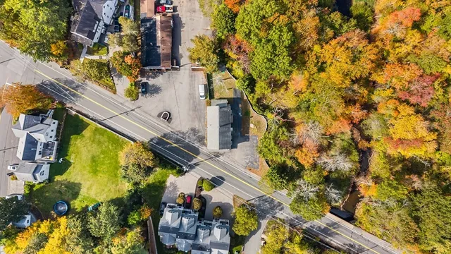 an aerial view of a residential apartment building with a yard
