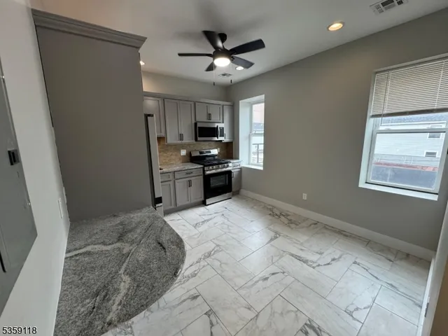 a view of kitchen with sink refrigerator and microwave