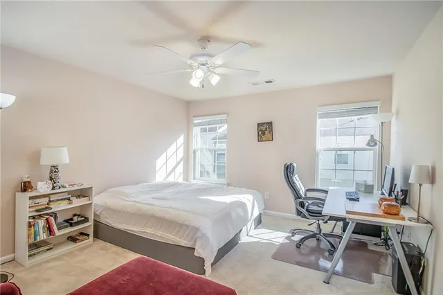 a bedroom with a bed and a desk