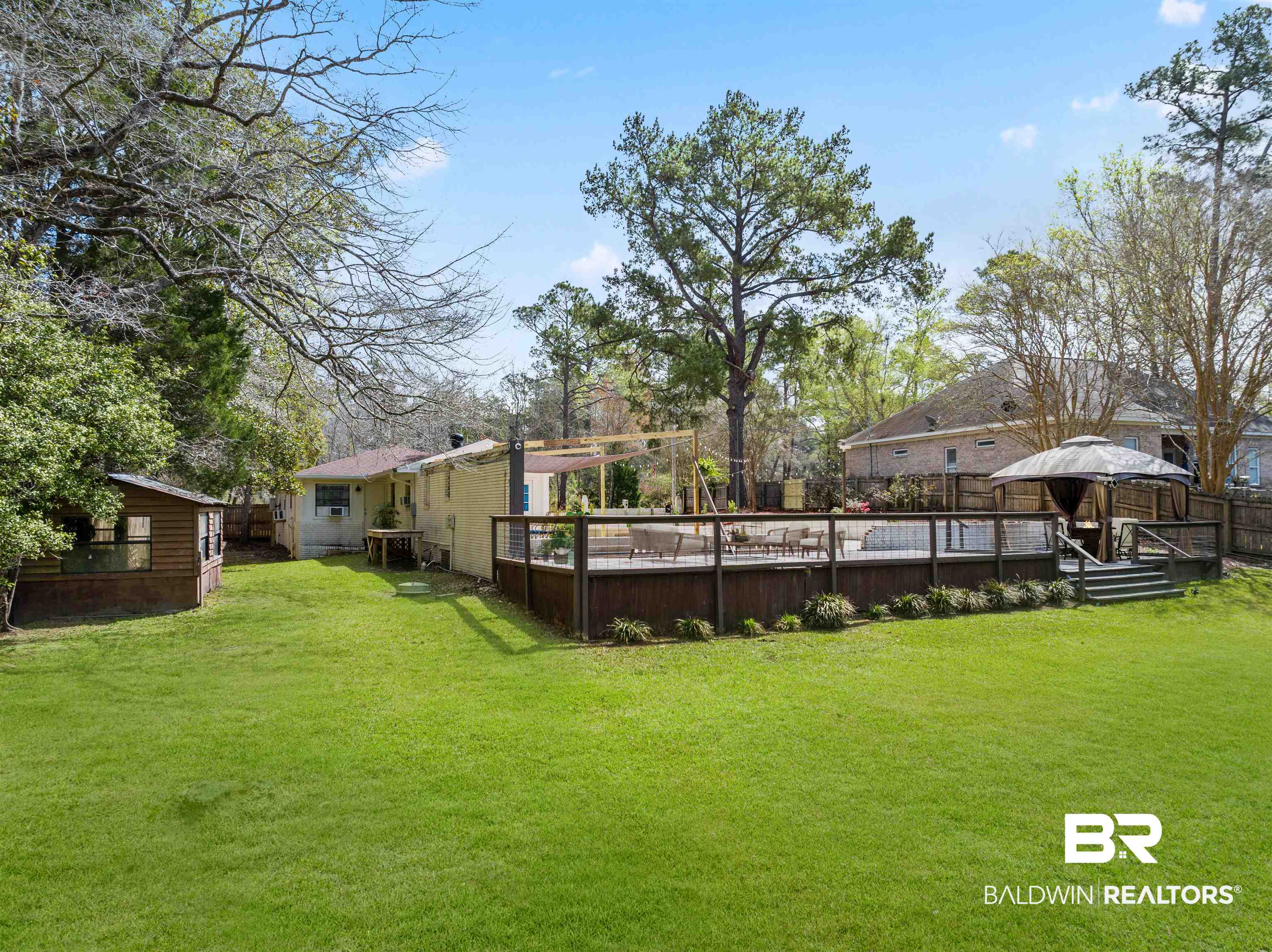 17595 River Road Summerdale, AL 36580 - Photo 25 of 29 Fenced yard featuring a gazebo and a wooden deck