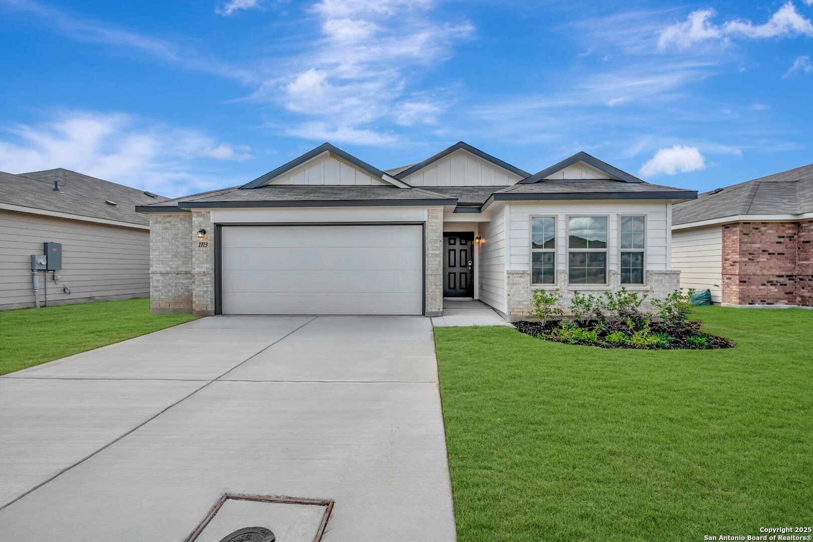 a front view of a house with a yard and garage