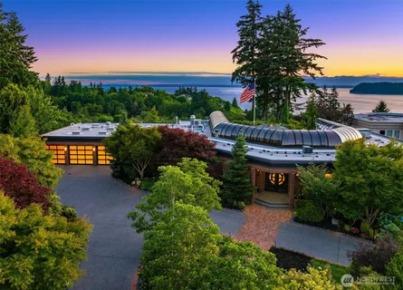 a view of a house with a yard and potted plants