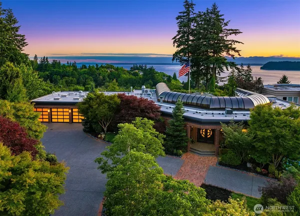 a view of a house with a yard and potted plants