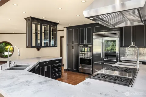 a kitchen with stainless steel appliances granite countertop a stove and a refrigerator
