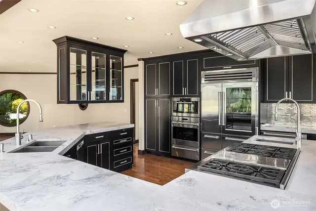 a kitchen with stainless steel appliances granite countertop a stove and a refrigerator
