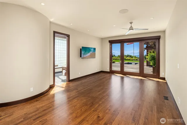 an empty room with wooden floor and a window