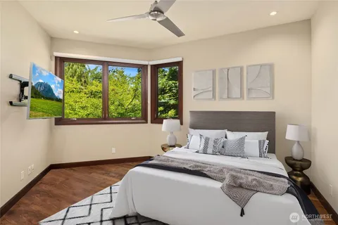 a bedroom with a bed and a large window