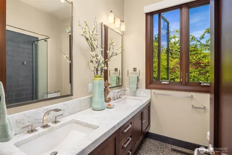 a bathroom with a granite countertop sink and a mirror