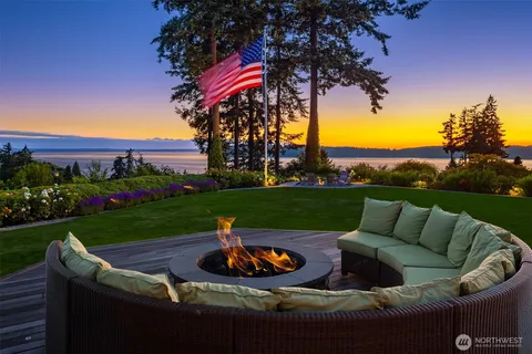a view of a patio with couches chairs potted plants and a yard